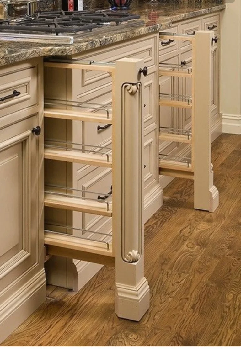 Narrow pull-out kitchen storage racks beside drawers beneath a worktop