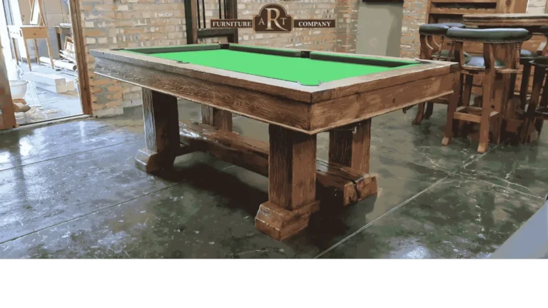 Rustic wooden pool table with green cloth and substantial trestle supports