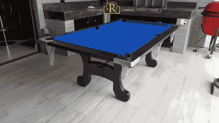 Dark pool table with blue cloth, curved legs and hanging net pockets