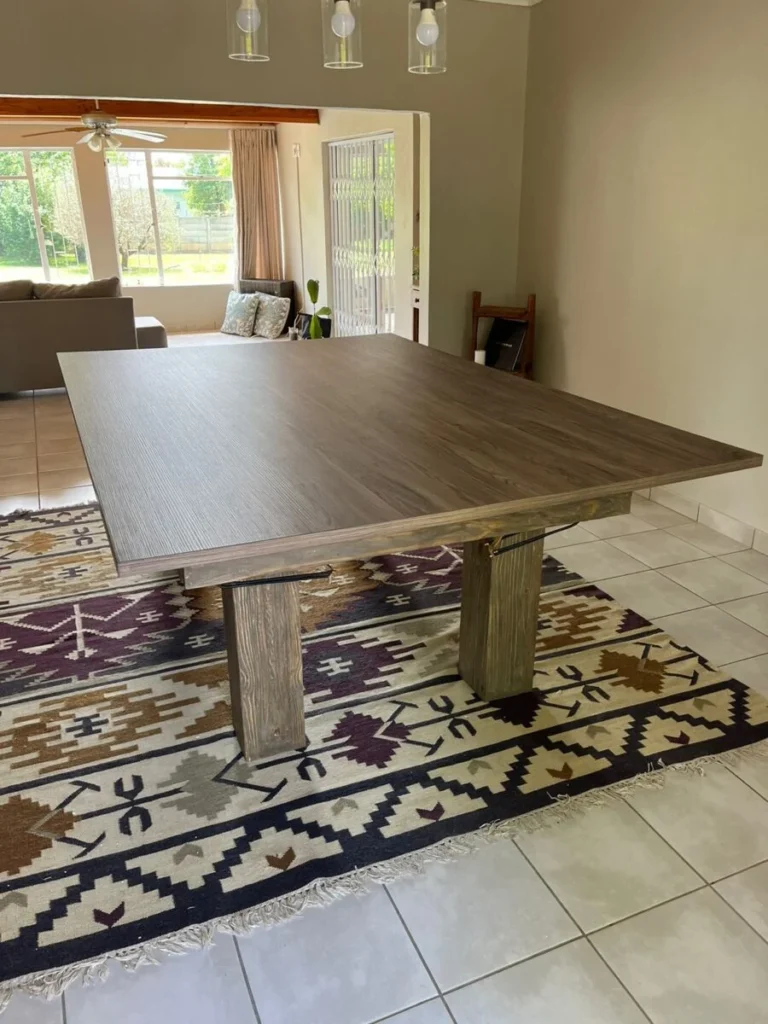 Wooden pool-dining table with its full timber dining top fitted in a living area