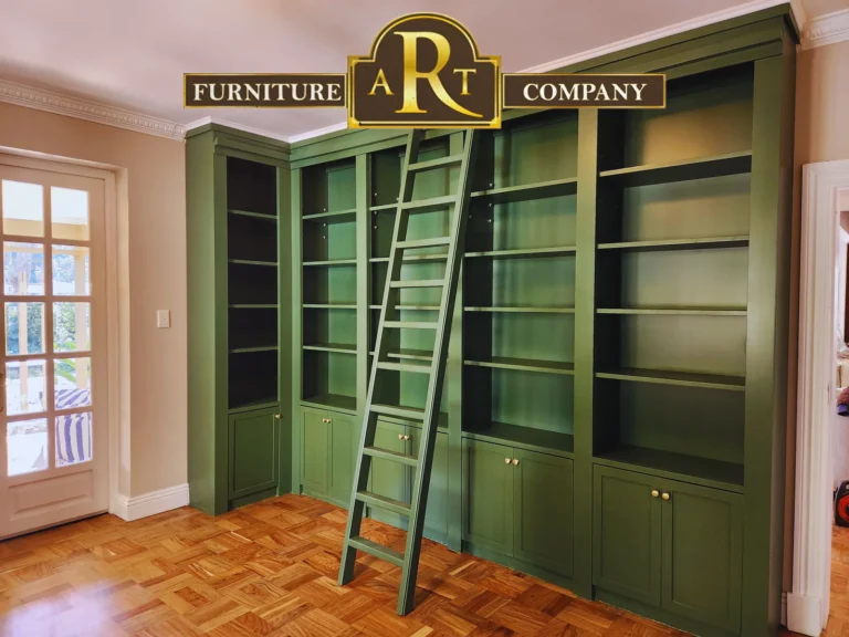 Green fitted library shelves and lower cupboards with a matching access ladder