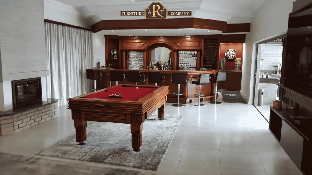 Wooden pool table with red cloth in a room with a fitted timber bar